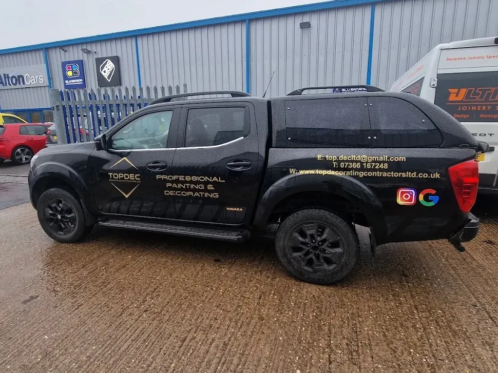 Black TopDec pickup with gold Professional Painting and Decorating signwriting