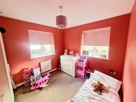 Child's bedroom painted red with white woodwork