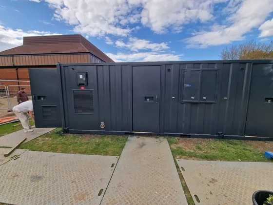 Steel site cabins painted dark grey