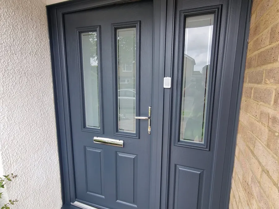 A dark grey composite front door with a smooth sprayed finish