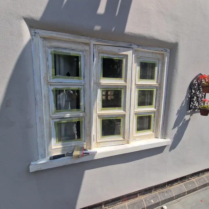 A six-pane window with the frame prepared and masked ready for paint